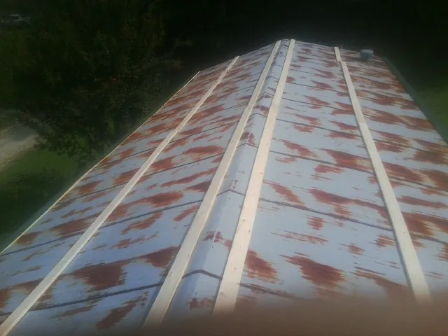 Rusted metal roof panels with new wood purlins before replacement — Storm Damage Roof Repair in Pioneer by Roofing Brothers
