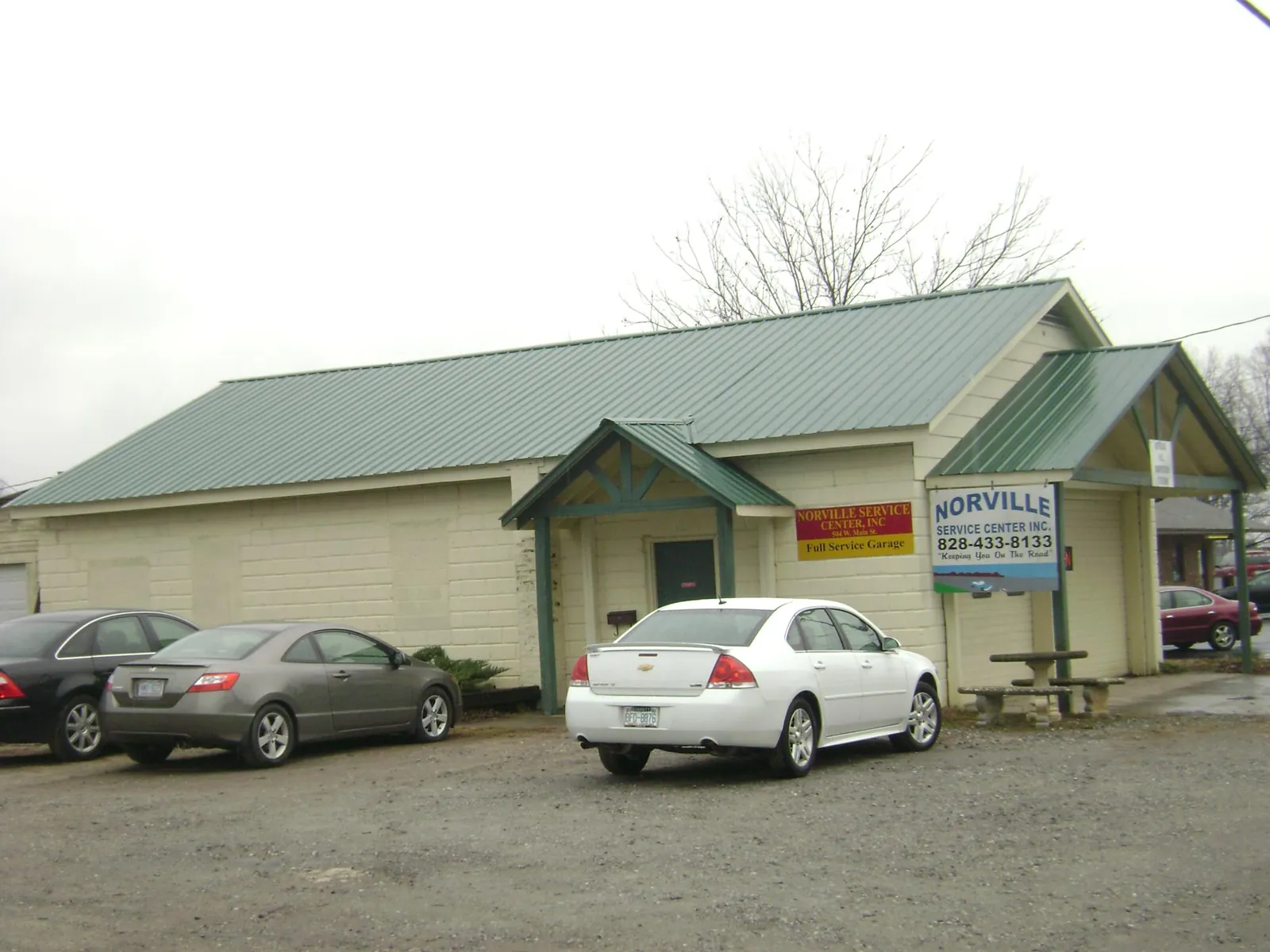 Green metal roof on a service garage with a covered entry in Pioneer